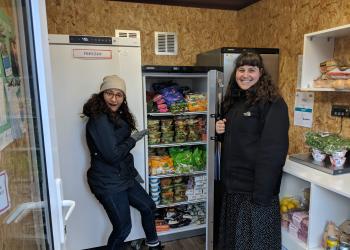 Volunteers opening a fridge at the Community Fridge