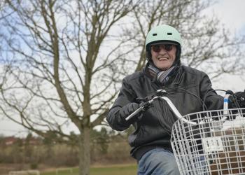 Man smiling on tricycle