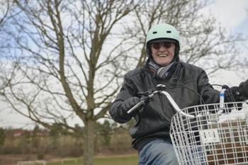 Man smiling on tricycle